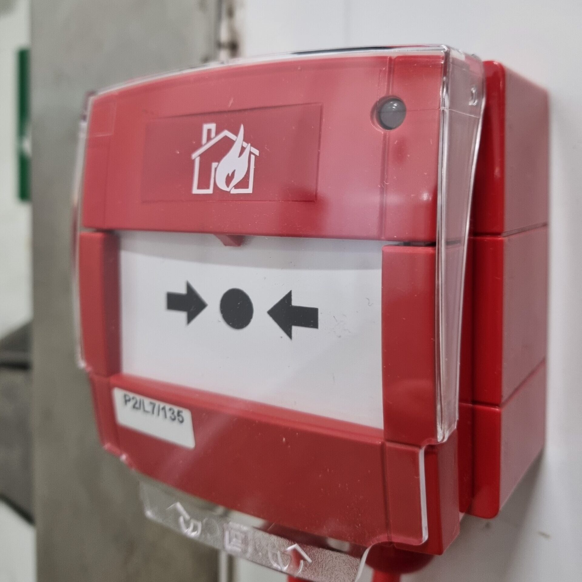 A red manual call point to press in the event of a fire