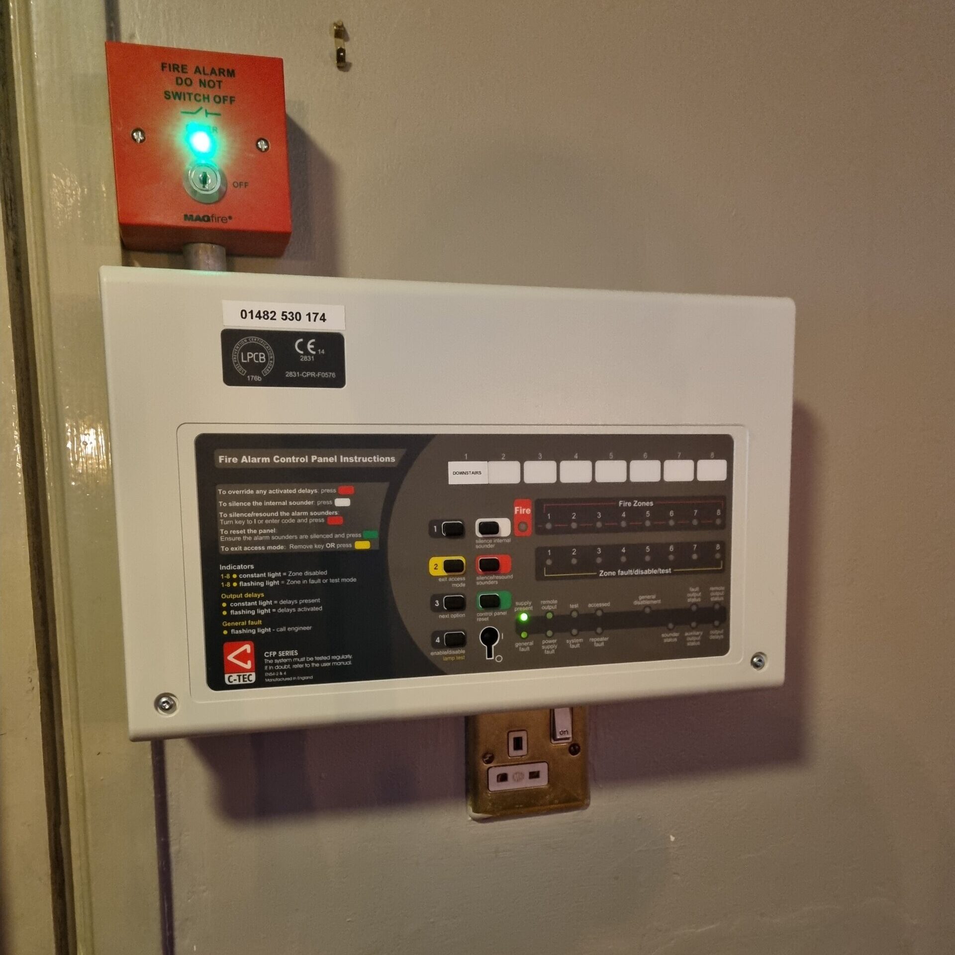 A fire alarm control panel mounted on a wall