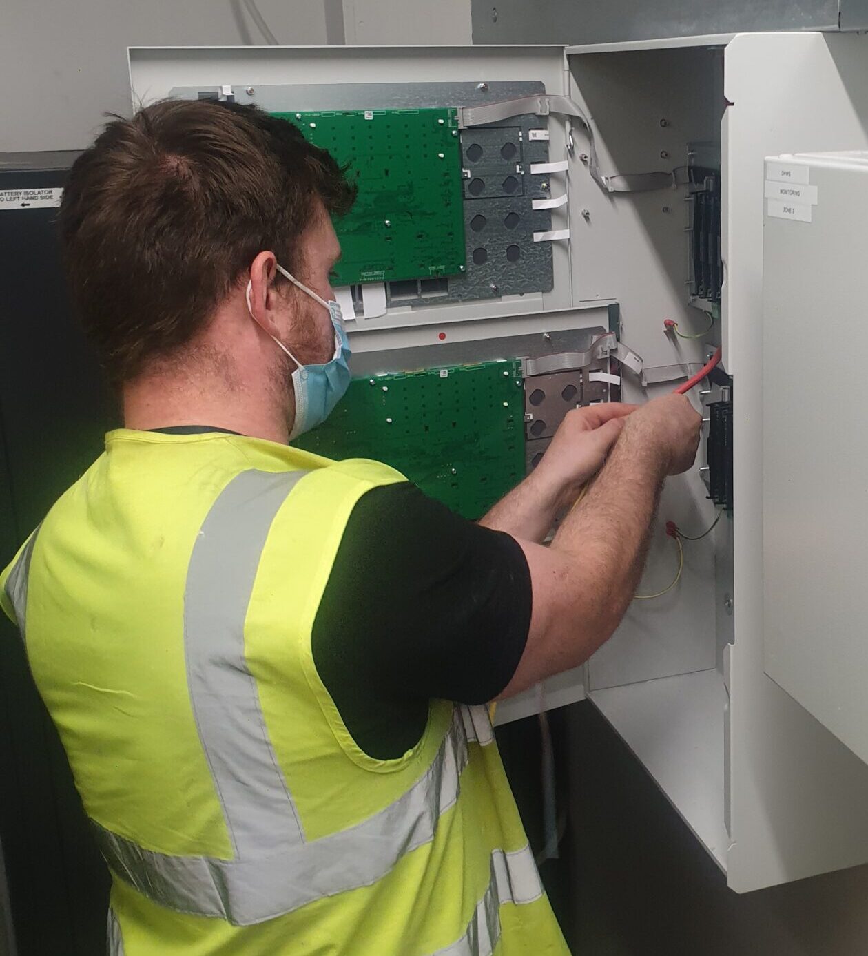 Engineer carrying out a repair on a Alarm System