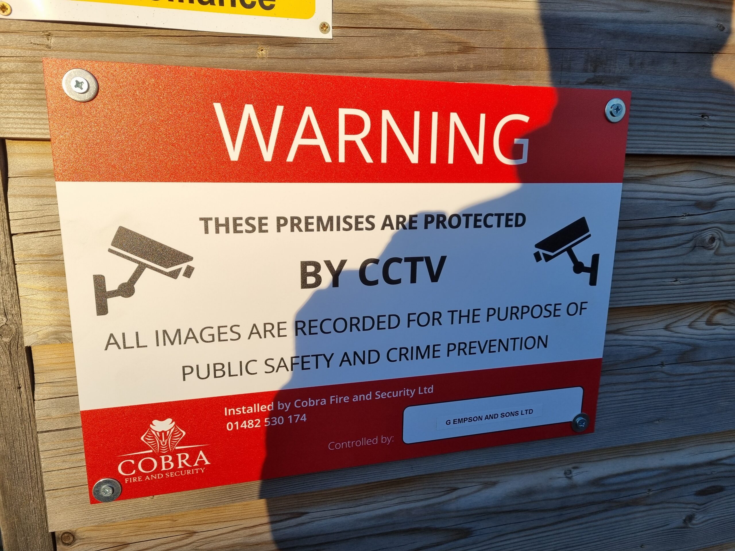 CCTV Signage mounted on a wooden wall