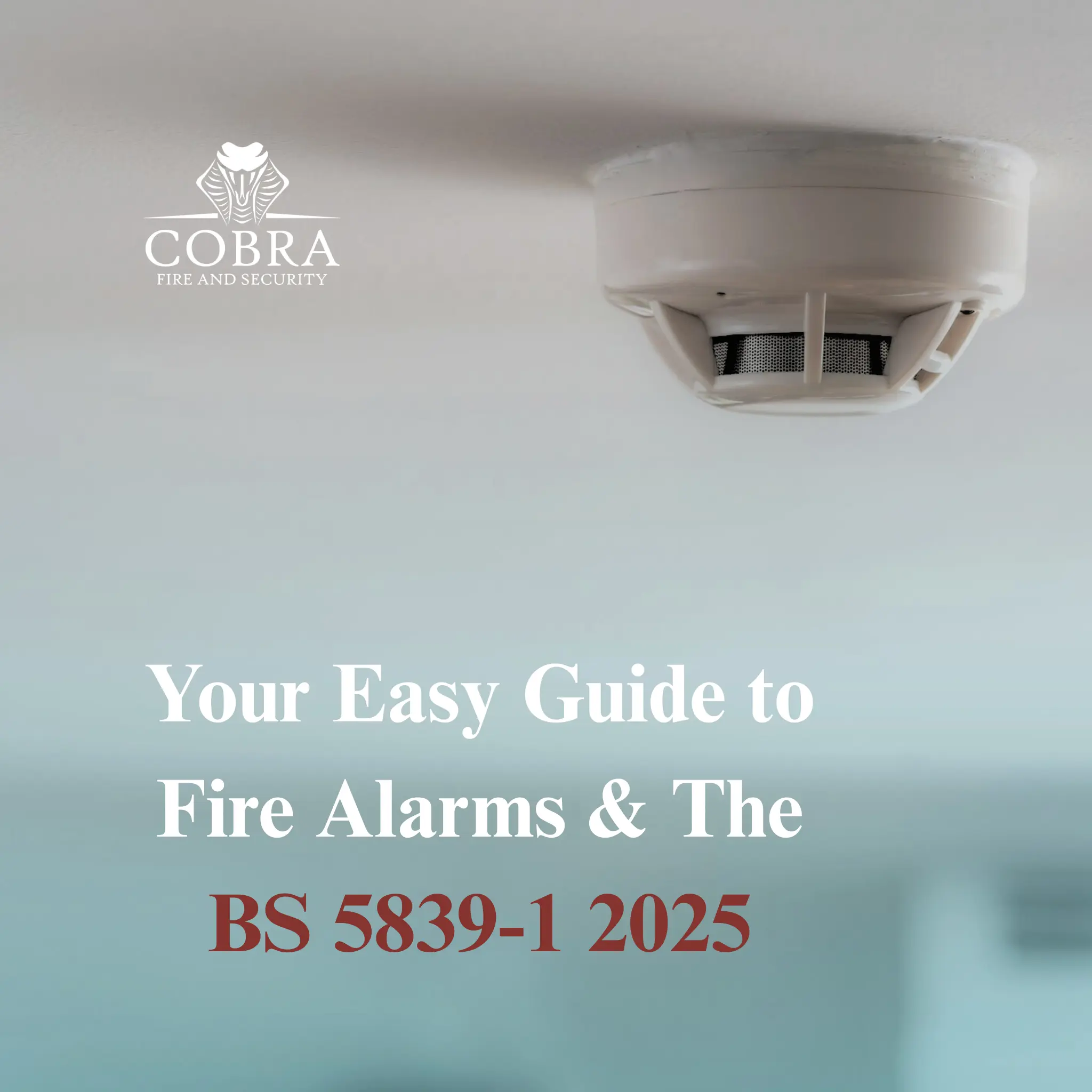 Your Easy Guide to Fire Alarms & The BS 5839-1 2025 Close-up of an Apollo smoke detector on a ceiling in an office setting, with blurred background. With the writing Your Easy Guide to Fire Alarms & the BS 5839-1 2025 underneath, along with the company logo for cobra fire and security ltd