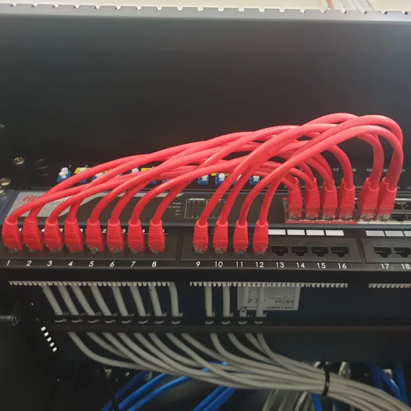 Red network cabled plugged into a netwprk patch panel