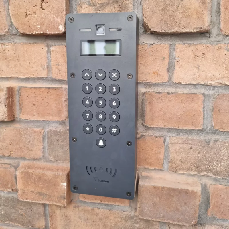 Black access control intercom that has a sidplay screen and buttons.