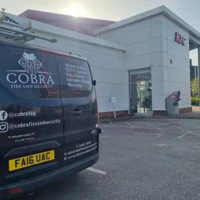 Image of the Van of Cobra Fire and Security parked outside a restaurant.