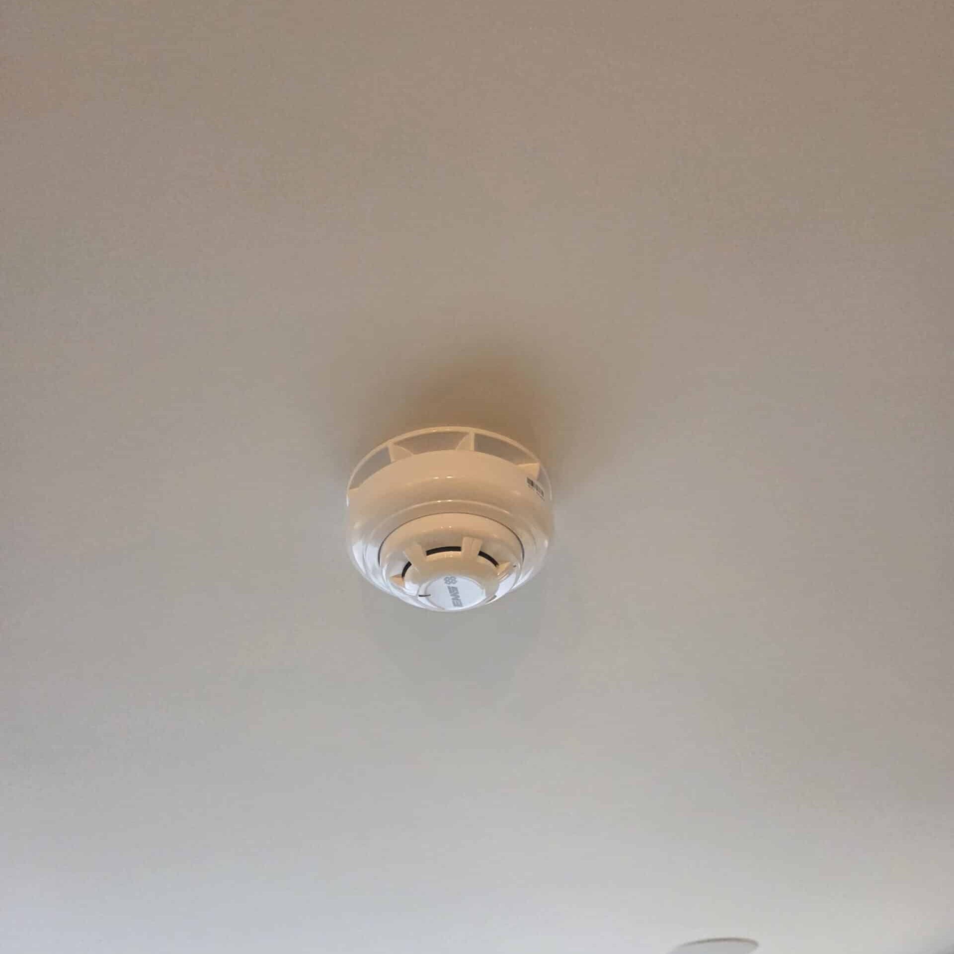 Wirless optical smoke detector on a ceiling